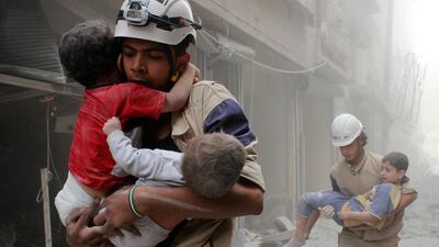 Members of the Civil Defence rescue children after an air strike in Aleppo in 2014. REUTERS