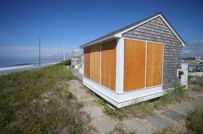 A beach house in Rhode Island, US, is boarded up in preparation for Hurricane Henri. AP.