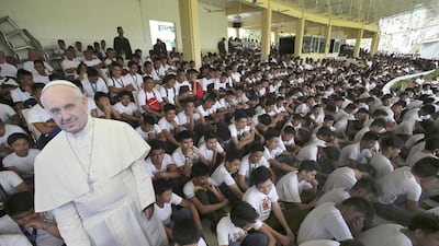 A cut-out picture of Pope Francis is surrounded by Filipino army reservist and volunteers during a briefing as part of security preparations for his visit to the Philippines. Aaron Favila/AP Photo