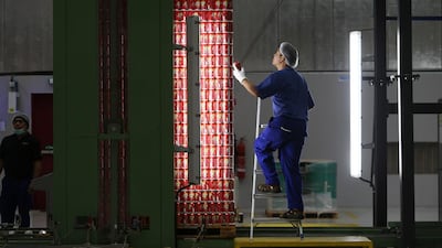 Above, inside a manufacturing plant at Dubai Investments Park in Dubai. Pawan Singh / The National