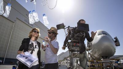 Directors Anthony Atanasio and Valerie Martinez, left, talk with production staff on the sets.