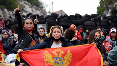Demonstrators gather at a barricade set up to block access roads to the historic city of Cetinje during a protest against the inauguration of the new head of the Serbian Orthodox Church on September 5, 2021 in Montenegro. - The new head of the Serbian Orthodox Church in Montenegro was inaugurated, arriving by helicopter under the protection of police who dispersed protesters with tear gas. The decision to anoint Bishop Joanikije as the new Metropolitan of Montenegro at the historic monastery of Cetinje has aggravated ethnic tension in the tiny Balkan state. (Photo by SAVO PRELEVIC / AFP)
