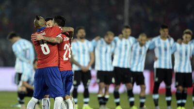 Chile's Arturo Vidal, Charles Aranguiz and Gary Medel celebrate after winning the Copa America final on Saturday in Santiago. Juan Mabromata / AFP