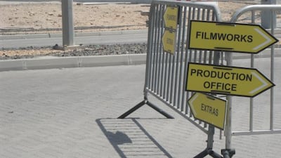 Signs outside Dubai Studio City on Monday. The National staff