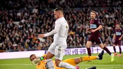 Real Madrid's Belgian forward Eden Hazard is sent tumbling by Celta Vigo's Spanish goalkeeper Ruben Blanc. AFP