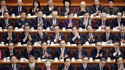 Delegates clap during the closing ceremony of the CPPCC at the Great Hall of the People, in Beijing, China. Jason Lee / Reuters