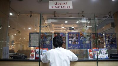 The view of the counter at an exchange bureau is a familiar sight for most expatriates. If you can afford to wait for a favourable exchange rate to send your money home, swings in currency values can bring great rewards. Razan alzayani / The National