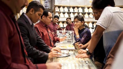Salesmen attend to customers at Kanz Jewels. “Everyone bargains, but not like the Indians,� jokes Deepak Dhora, 30, the manager. “It’s not the language, but for them it is an investment so there is more in it.�