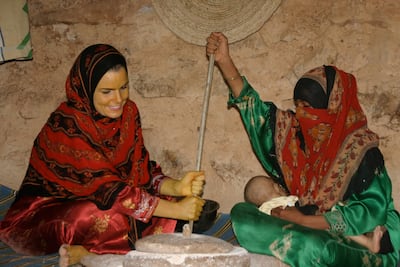 Grinding wheat in the countryside, Socotra. Nathalie Peutz is seated on the left, her face and hands yellowed with turmeric powder (a local sunscreen), 2005. Courtesy Nathalie Peutz
