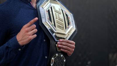 A man holds the belt at the UFC fan zone. Yas Island, Abu Dhabi. Chris Whiteoak / The National