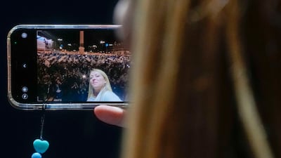 Giorgia Meloni snaps a selfie at a rally in Rome. AP