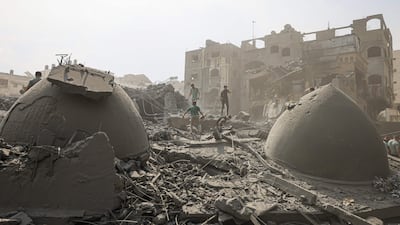 Palestinians inspect the damage after an Israeli air strike on Al Sousi mosque in Gaza city. AFP
