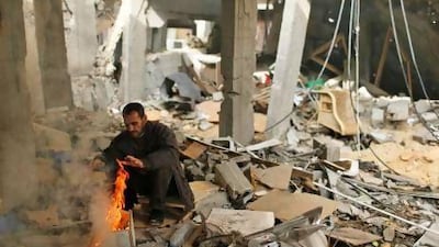 A Palestinian warms himself at the rubble of his house destroyed in an Israel air strike during last week’s strike on Gaza. Diplomats say greater UN recognition would help to heal Fatah’s political wounds.