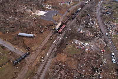 A derailed train is seen amid damage and debris after a devastating outbreak of tornadoes ripped through several US states in Earlington, Kentucky. Reuters