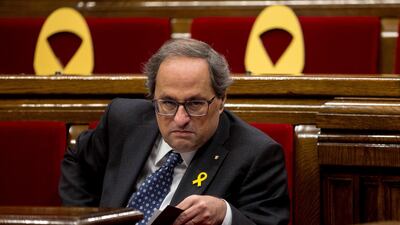 Catalan regional president, Quim Torra, sat next to several yellow ribbons, placed in support of imprisoned Catalan politicians. EPA.