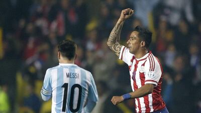Paraguay's Lucas Barrios, right, celebrates after scoring against Argentina to make it 2-1 in the first half as he runs by Lionel Messi during Tuesday's Copa America semi-final. Ricardo Mazalan / AP