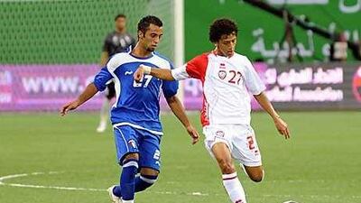 The UAE's Amer Abdulrahman, right, fends off a challenge during the Under 23 Gulf Cup draw with Kuwait.