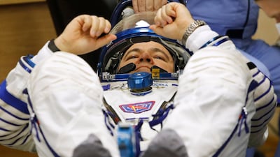 Oleg Skripochka has his space suit inspected before launch. Dmitri Lovetsky / AP