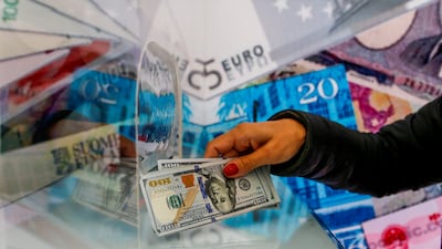 A money changer sells US dollar bills at a currency exchange office. The global economy is expected to register 'stable growth' in 2023, according to Moody's Investor Service. Reuters