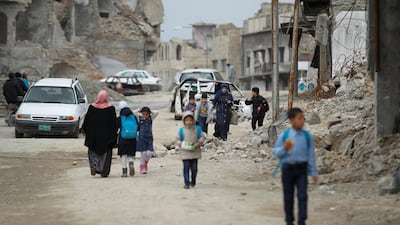 Iraqi school students pass by destroyed buildings by the war, in the Old City of Mosul, Iraq February 27, 2019. Reuters
