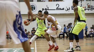 Denok Miranda of GlobalPort Batang Pier tries to dribble by Paul Lee of Rain or Shine Elasto Painters on Thursday in their PBA game in Dubai. Antonie Robertson / The National