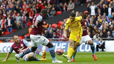 Liverpool's Philippe Coutinho shoots and scores to make it 1-0 in the first half against Aston Villa in the FA Cup semi-final on Sunday. Darren Staples / Reuters