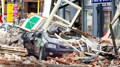 Cars crushed under fallen rubble on Manchester Street two days after a deadly 6.3 magnitude earthquake in Christchurch, February 24, 2011. AFP