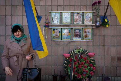 A widowed Ukrainian at a memorial to people killed in Bucha, Ukraine, in April 2022. AP