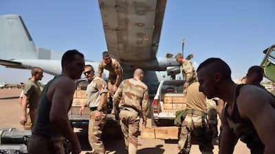 French troops carry weapons at the 101 military airbase near Bamako before their deployment to the north of Mali. France is using both air and ground power in the joint offensive with Malian soldiers AFP