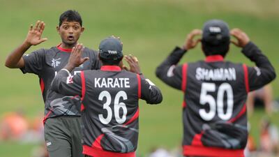 Amjad Javed, left, Krichnachandran Karate, Shaiman Anwar and the rest of the UAE cricket team arrived back in the country early Wednesday morning. Ross Setford / AP Photo
