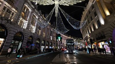 Members of the public look at the annual Christmas lights on Regent Street in central London. AFP