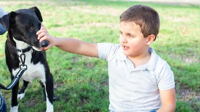 Sam with Otis. Sam’s condition makes him very tactile, and he likes to touch and hug others. Courtesy: Em Ray