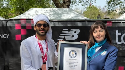 Sadique Ahamed being presented with a certificate for his achievement at the end of this year's London Marathon. Photo: Guinness World Records