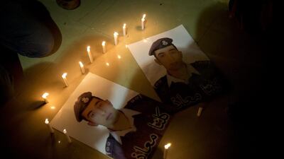 Members of Al Kassasbeh, the tribe of Jordanian pilot Lieutenant Maaz Al Kassasbeh, who is being held by ISIL militants, light candles by posters with his picture that read "We are all Maaz," in his home town of Karak, Jordan on January 31, 2015. Nasser Nasser/AP Photo