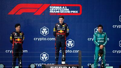 Race winner Max Verstappen, centre, with second-placed Sergio Perez, left, and Fernando Alonso, right, who finished third. Getty