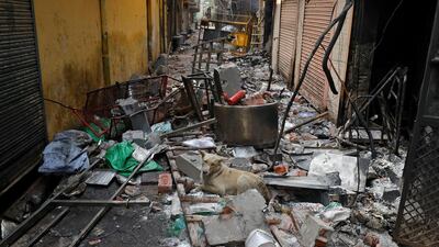 A dog sits on the remains of a damaged house that was set on fire by a mob in a riot affected area after clashes erupted in New Delhi. Reuters