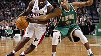 The Boston Celtics guard Rajon Rondo, right, reaches in to knock the ball away from Pistons's Will Bynum.