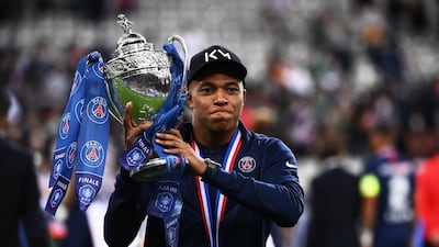 Mbappe celebrates with the trophy. AFP