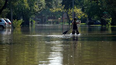 A woman paddles down her street covered by Harvey floodwaters in north western Houston, Texas, on August 31, 2017. Rick Wilking/ Reuters