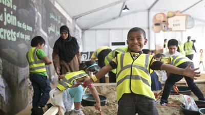 Abdullah, 5, takes part in an archaeological dig at the 2014 Abu Dhabi Science Festival on the Abu Dhabi Corniche. Mona Al Marzooqi / The National