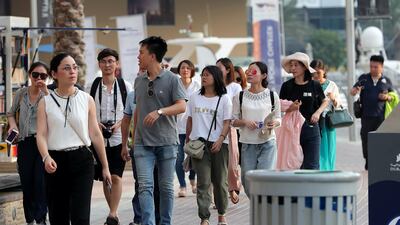 Tourists enjoying the Marina Walk at Dubai Marina. The new transit-visa rules mean travellers can enter the country for up to 48 hours without needing to pay entry fees. Pawan Singh / The National