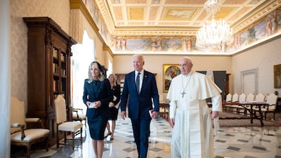 Joe Biden, his wife Jill Biden and Pope Francis walk as they meet at the Vatican. AP Photo