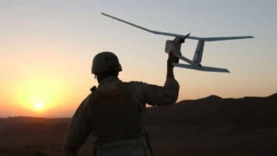 A US soldier holds a small spy drone.