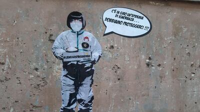 The mural in Rome depicts a local Chinese restaurant owner saying 'There is an epidemic of ignorance around ...... We must protect ourselves'. EPA