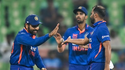 Mohammed Shami (R) celebrates after taking the wicket of Charith Asalanka. AFP