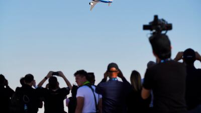 A crowd watches a Boeing 777X fly at the Dubai Airshow. AP Photo