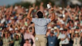Rory McIlroy celebrates winning his second consecutive Masters tournament on the 18th green at Augusta. Getty Images