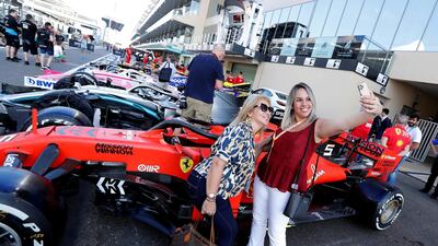 Fans take a selfie with the cars ahead of the Abu Dhabi Grand Prix. Reuters