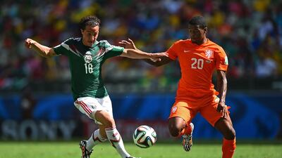 Andres Guardado of Mexico and Georginio Wijnaldum of the Netherlands compete for the ball during their match on Sunday at the 2014 World Cup in Fortaleza, Brazil. Laurence Griffiths / Getty Images
