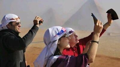 Venezuelan tourists watch a partial solar eclipse in front of the Giza Pyramids. Amr Nabil / AP